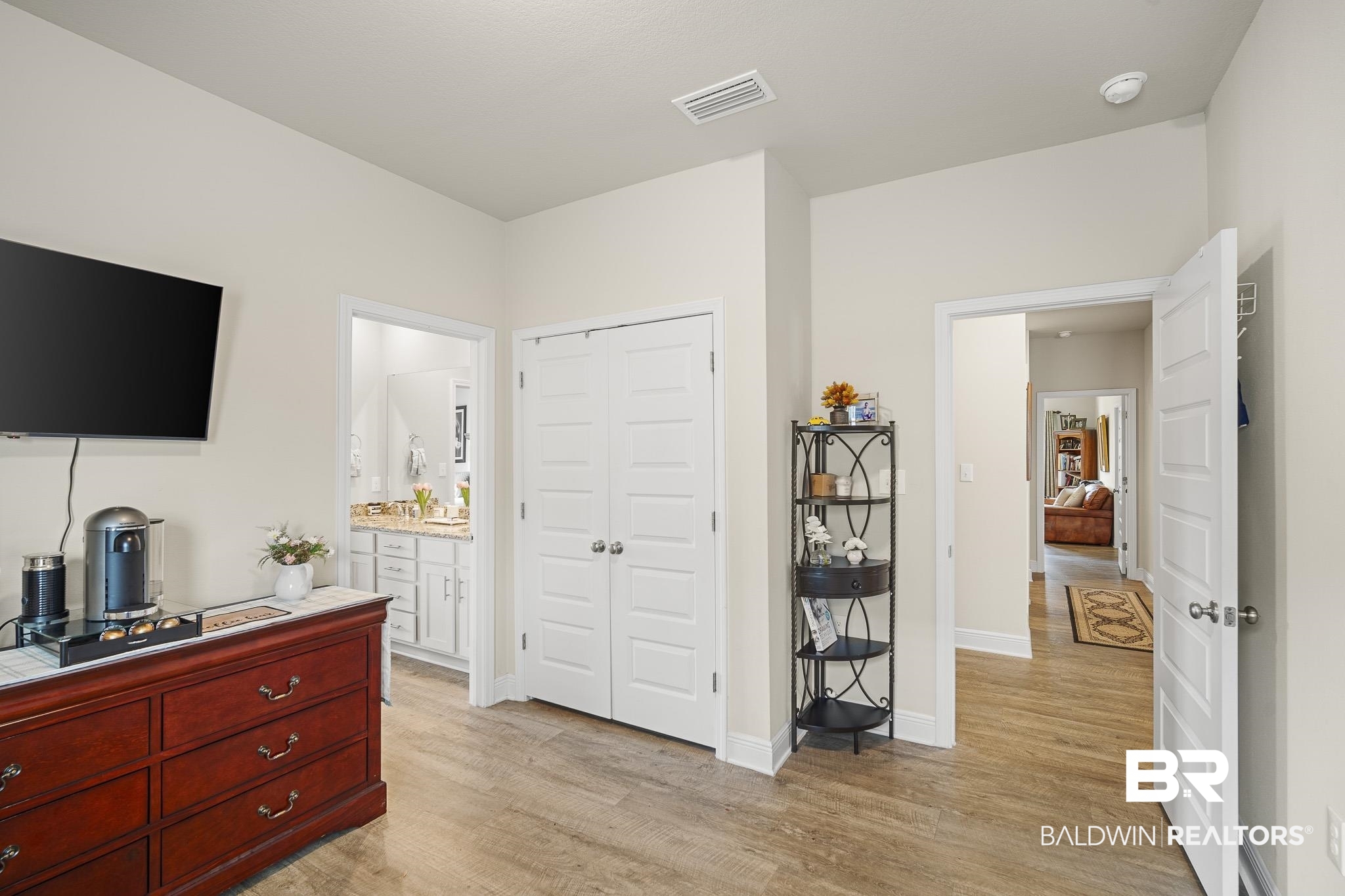 24765 Spectacular Bid Loop Daphne, AL 36526 - Photo 32 of 45 Bedroom featuring connected bathroom, light hardwood / wood-style flooring, and a closet