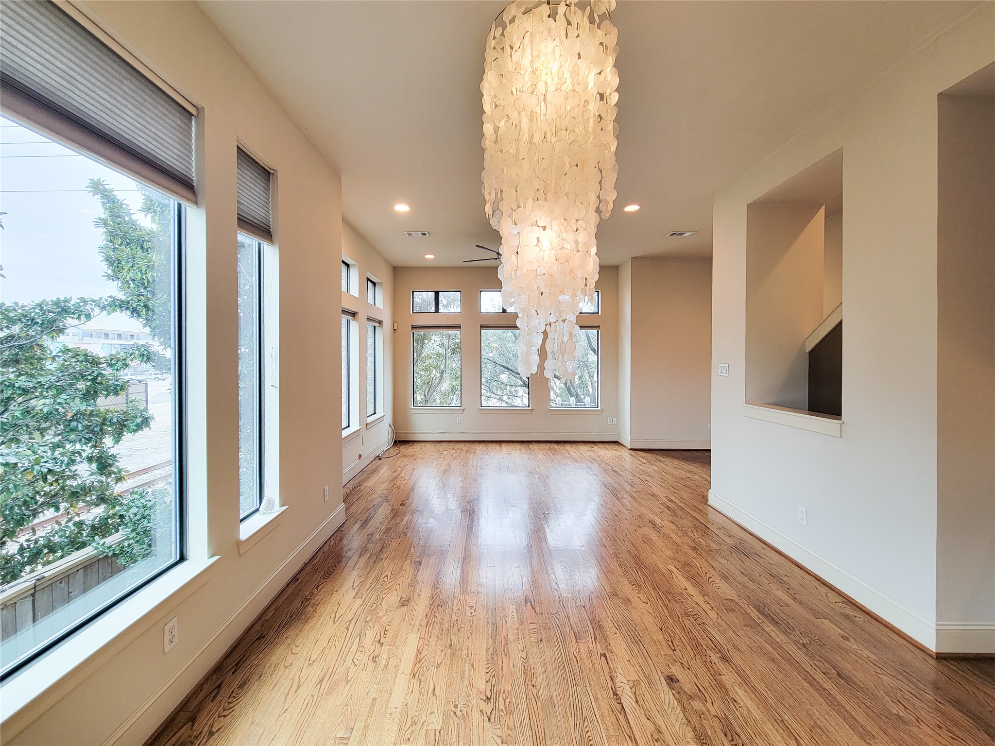 1602 White Street Houston, TX 77007 - Photo 11 of 41 a view of an empty room with wooden floor and a window