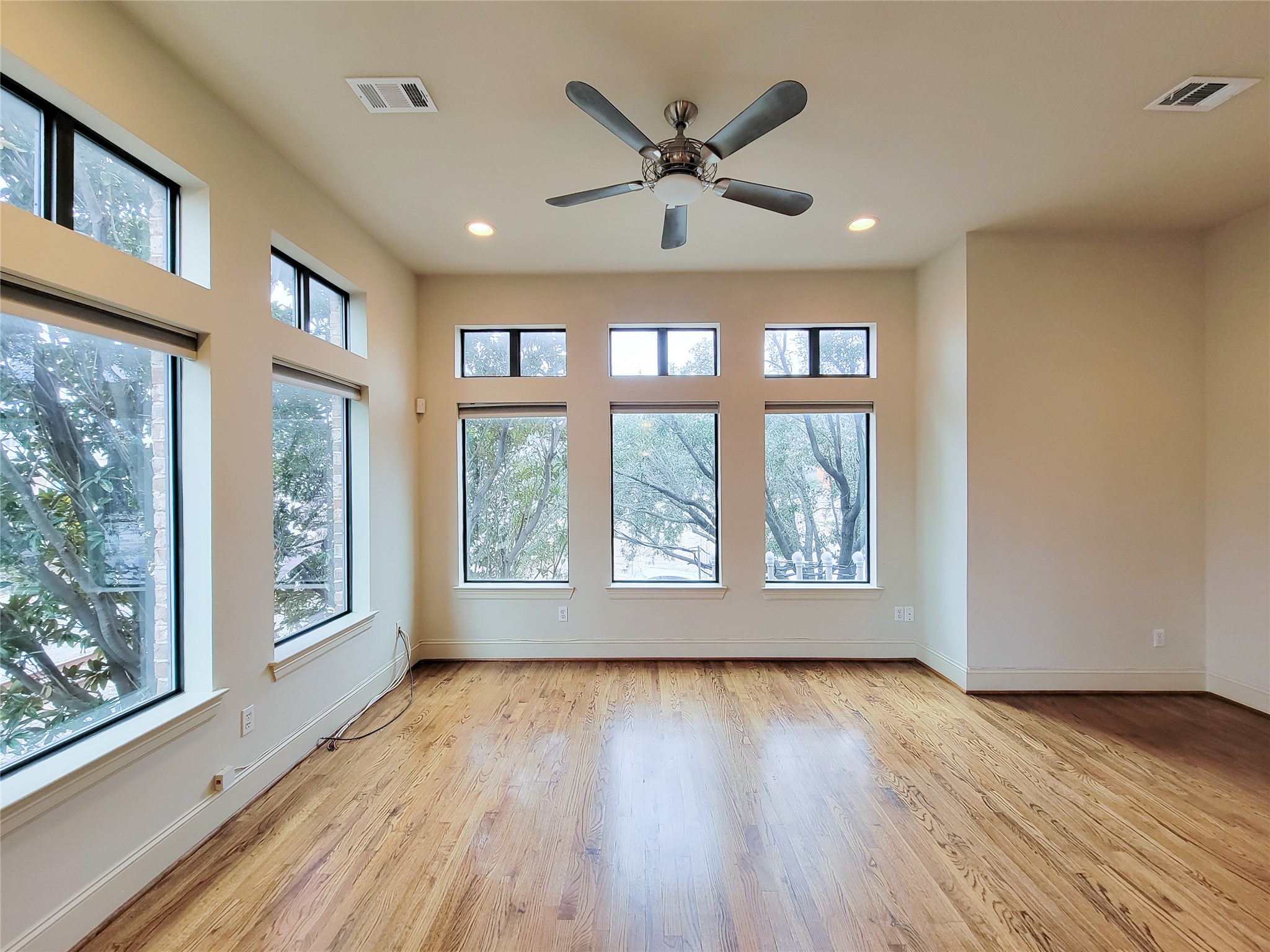 1602 White Street Houston, TX 77007 - Photo 13 of 41 a view of an empty room with wooden floor and a window