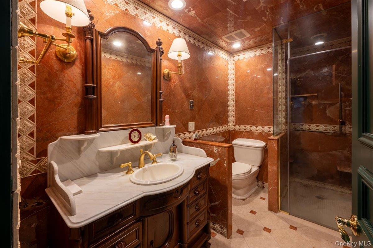 1331 Harbor Road Hewlett, NY 11557 - Photo 24 of 50 Full bath with tile walls, vanity, a shower stall, and tile patterned flooring