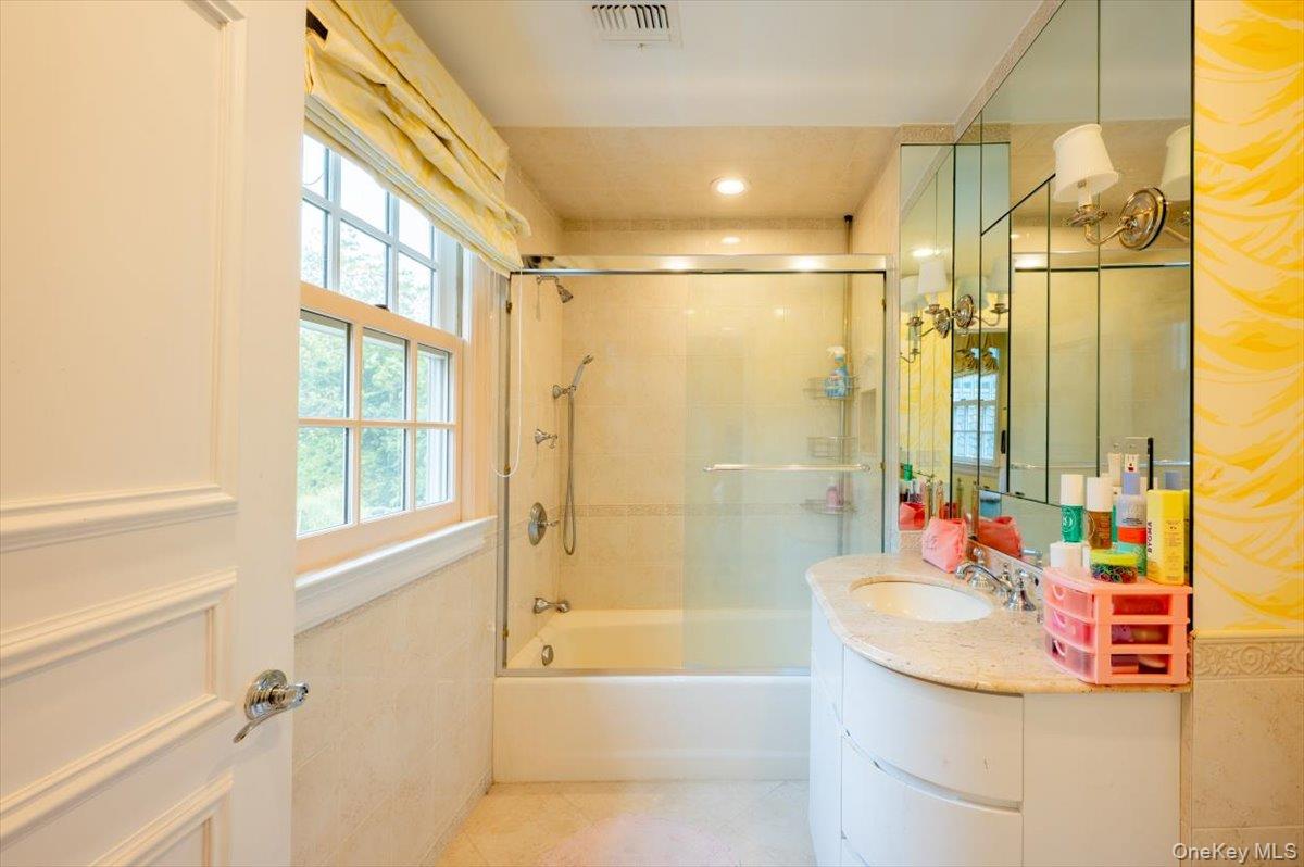 1331 Harbor Road Hewlett, NY 11557 - Photo 30 of 50 Bathroom featuring vanity, combined bath / shower with glass door, and tile patterned flooring