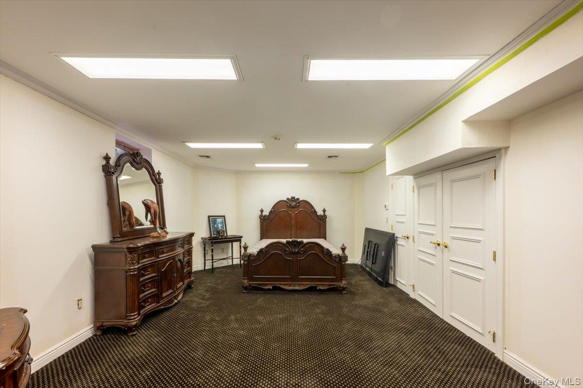 1331 Harbor Road Hewlett, NY 11557 - Photo 35 of 50 Bedroom featuring dark carpet and ornamental molding