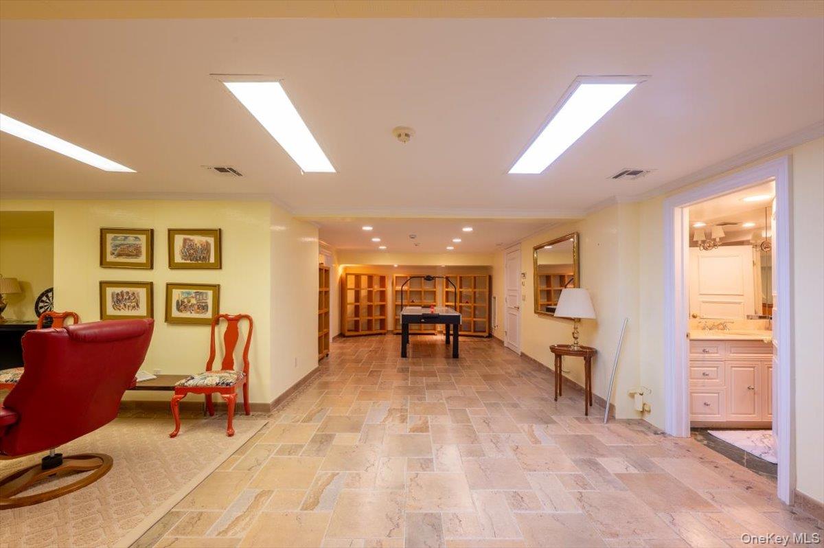 1331 Harbor Road Hewlett, NY 11557 - Photo 37 of 50 Rec room featuring ornamental molding, stone tile floors, and recessed lighting