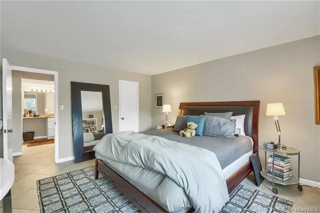 a bedroom with a bed and a mirror