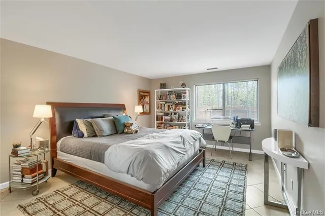 a bedroom with a bed and a large window