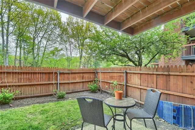 a view of a chair and table in the patio