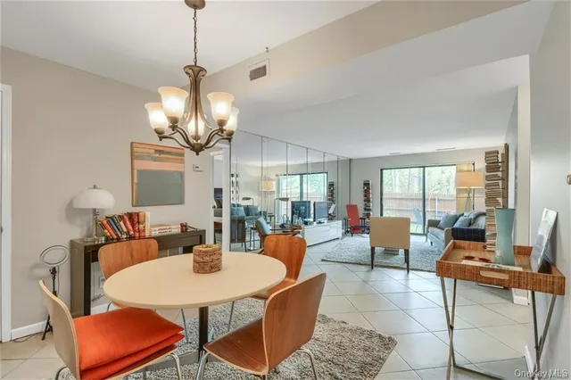 a view of a dining room with furniture wooden floor and chandelier