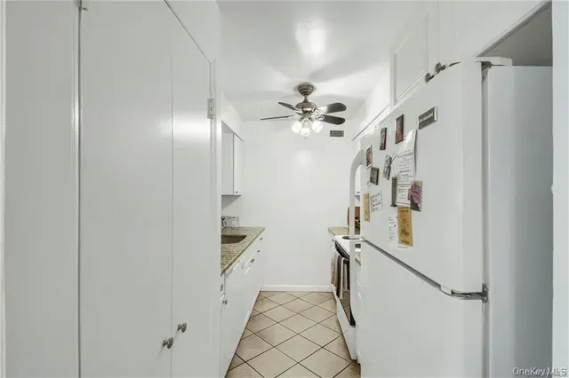 a view of hallway with stairs and a chandelier
