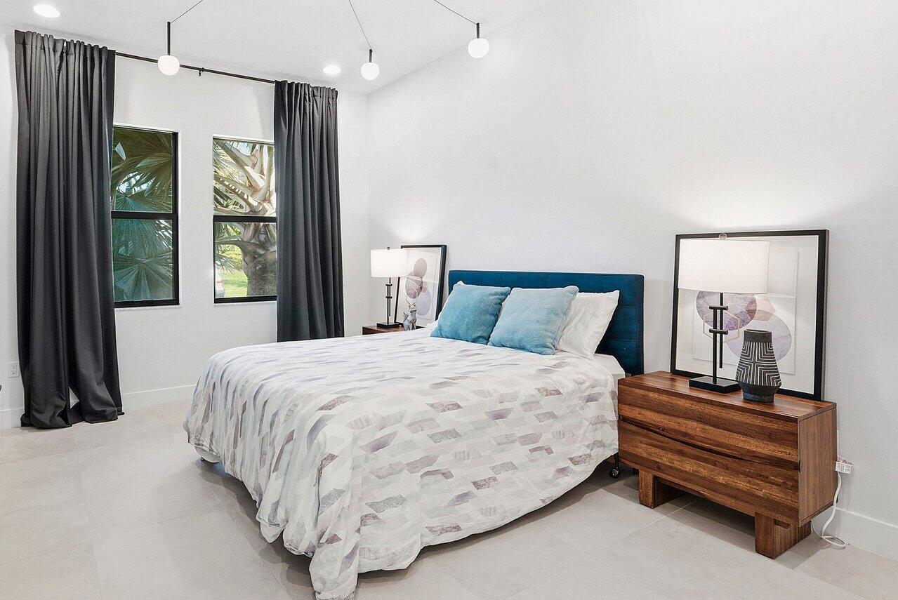 8092 Laurel Falls Drive Boca Raton, FL 33496 - Photo 25 of 62 a bedroom with a bed and a large mirror