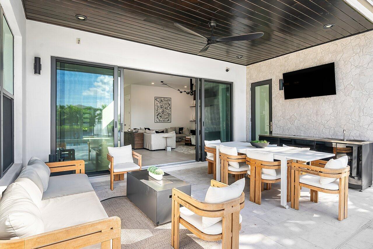 8092 Laurel Falls Drive Boca Raton, FL 33496 - Photo 31 of 62 a outdoor space with patio the couches and a dining table with the view of the balcony