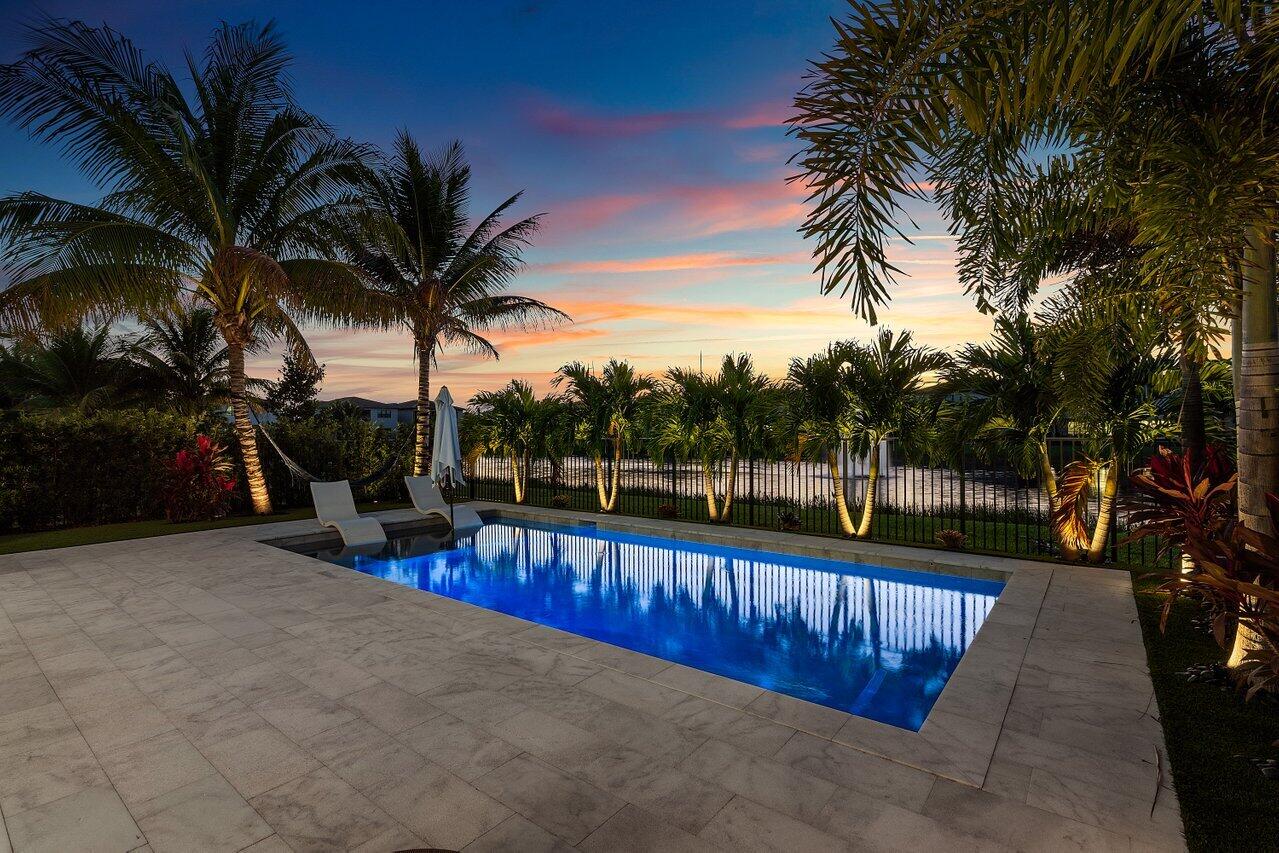 8092 Laurel Falls Drive Boca Raton, FL 33496 - Photo 38 of 62 a view of a swimming pool with a table and chairs