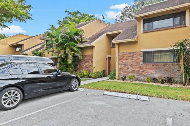 a view of a car parked front of a house