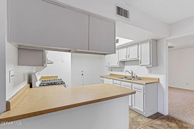 a view of a kitchen with electric appliances