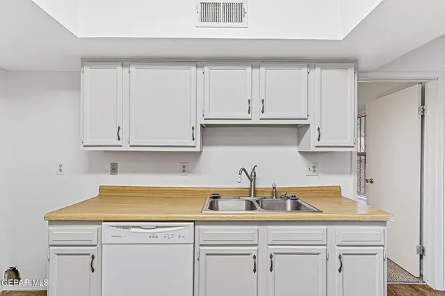 a kitchen with white cabinets and a sink