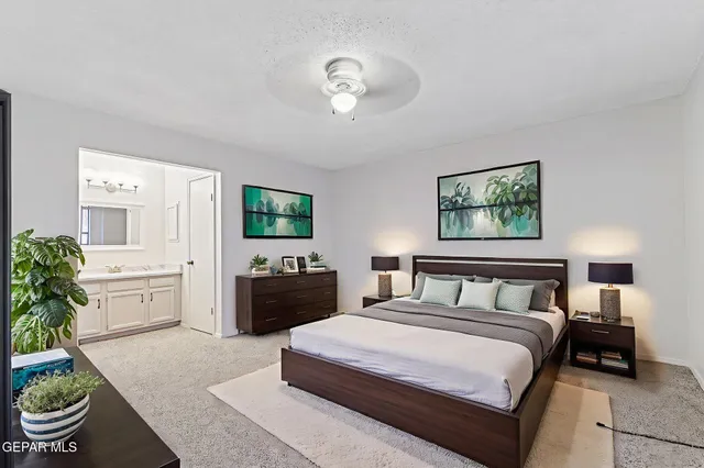 a bedroom with a bed and a potted plant