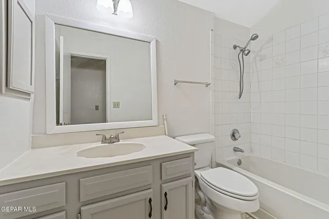a bathroom with a sink toilet a mirror and shower