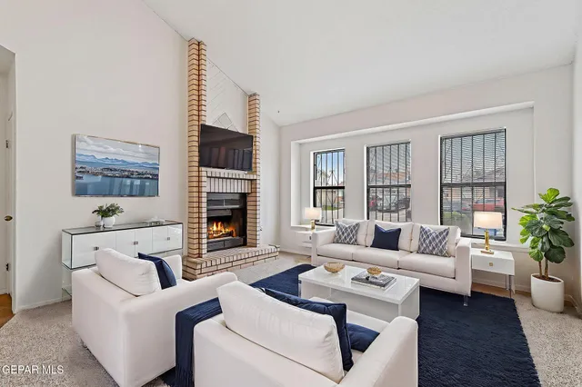 a living room with furniture fireplace and a flat screen tv