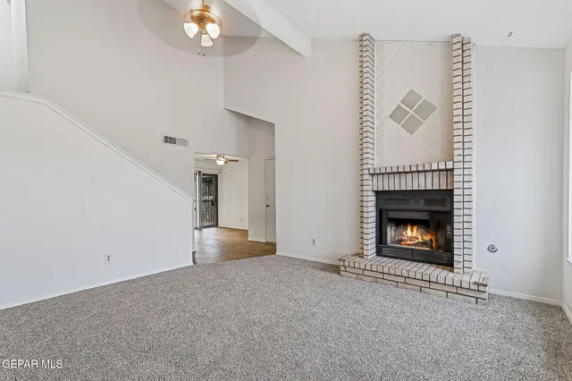 a view of empty room with fireplace