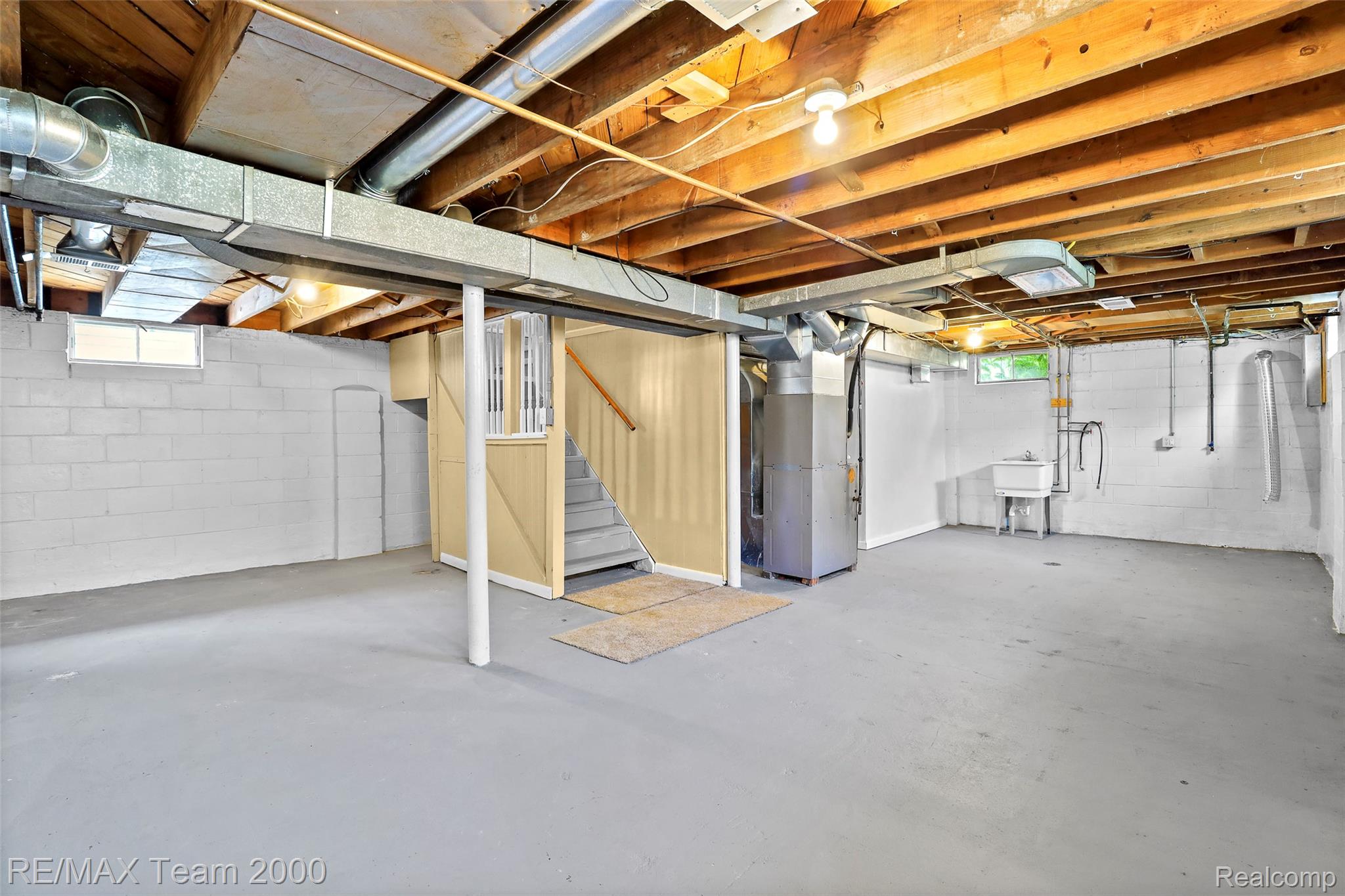 3130 Chestnut Street Dearborn, MI 48124 - Photo 22 of 30 Spacious lower-level area featuring painted cinder block walls and exposed ceiling joists