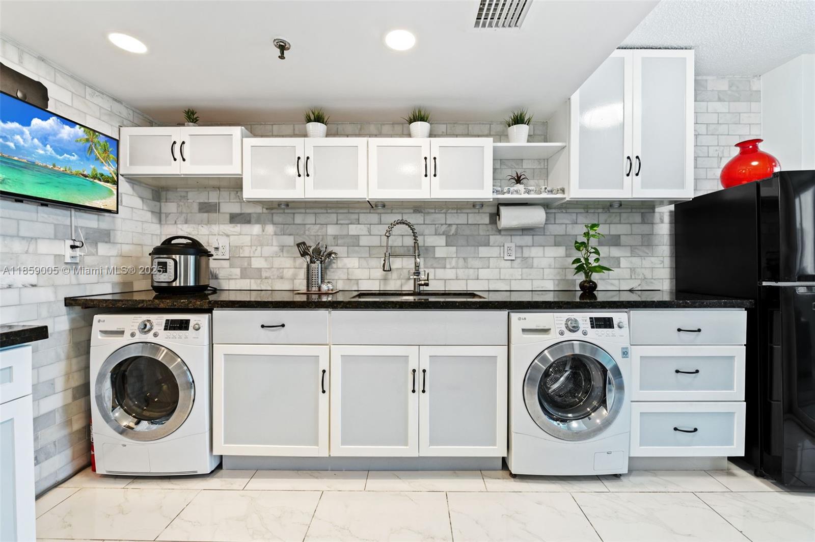 17890 West Dixie Highway, Unit 603 Miami, FL 33160 - Photo 12 of 34 a kitchen with a stove top oven sink and cabinets