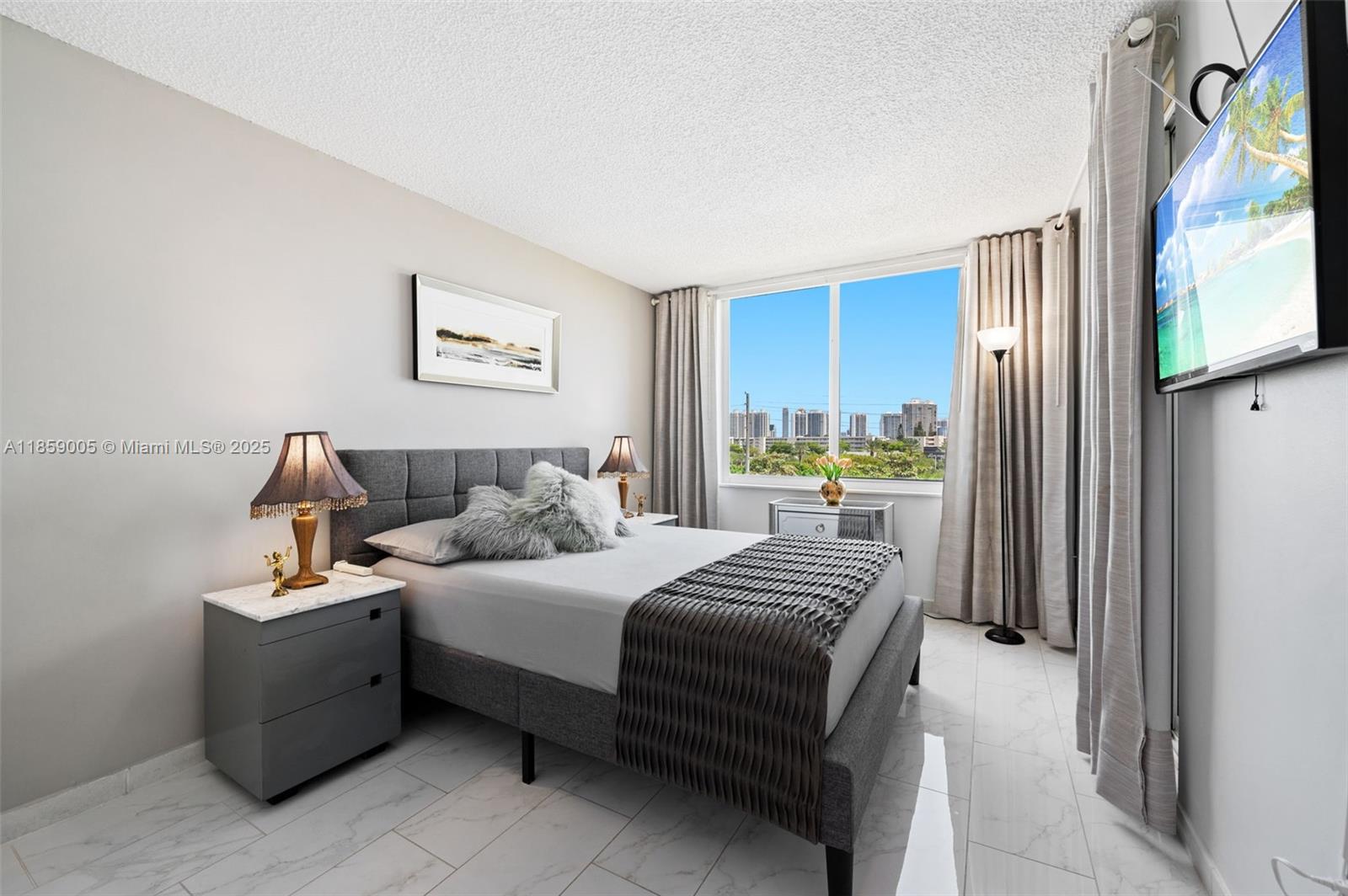 17890 West Dixie Highway, Unit 603 Miami, FL 33160 - Photo 16 of 34 a bedroom with a bed and a large mirror