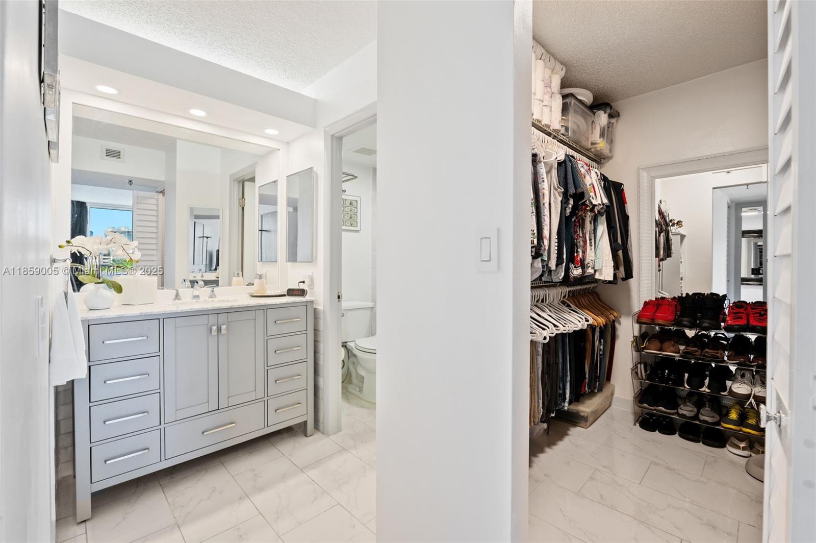 17890 West Dixie Highway, Unit 603 Miami, FL 33160 - Photo 18 of 34 a view of walk in closet with clothes and shoes