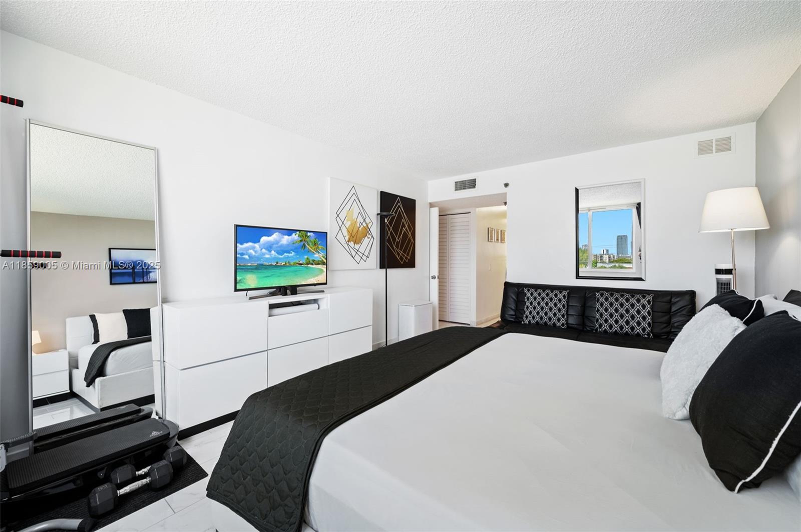 17890 West Dixie Highway, Unit 603 Miami, FL 33160 - Photo 21 of 34 a bedroom with a bed and a flat screen tv