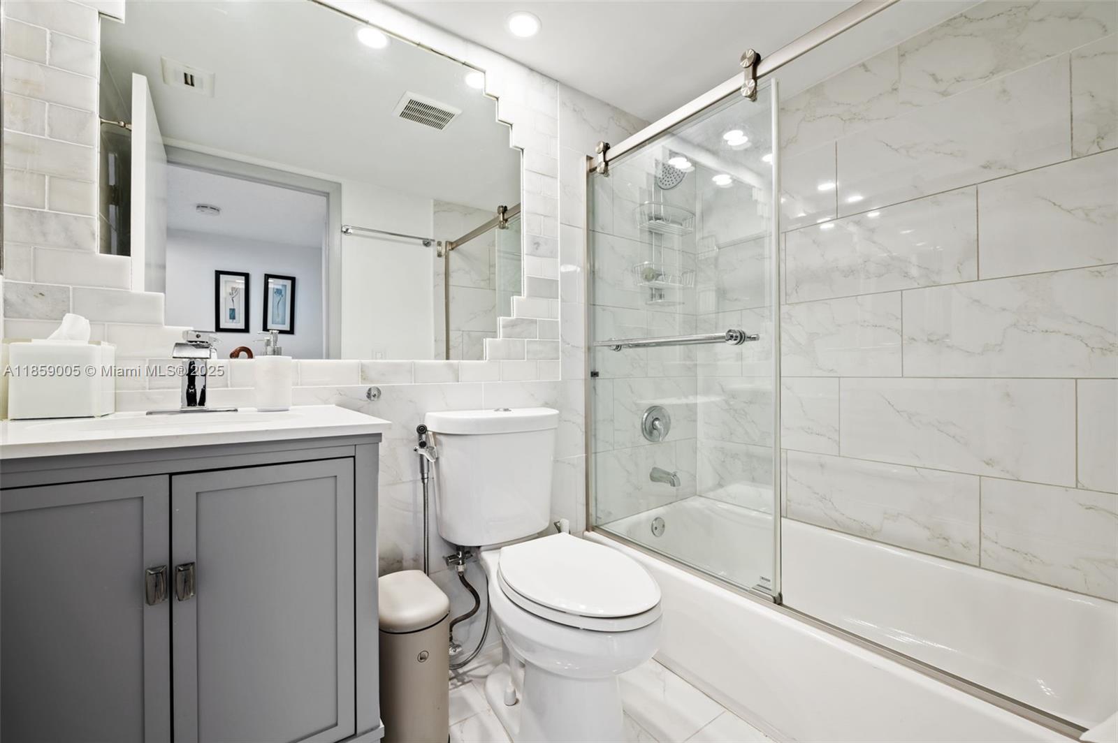 17890 West Dixie Highway, Unit 603 Miami, FL 33160 - Photo 22 of 34 a bathroom with a sink toilet and shower