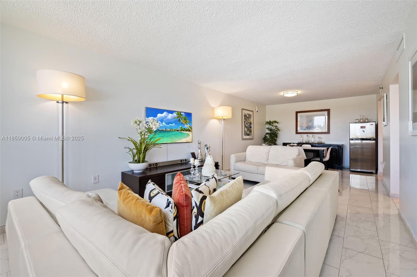 17890 West Dixie Highway, Unit 603 Miami, FL 33160 - Photo 7 of 34 a living room with furniture and a lamp