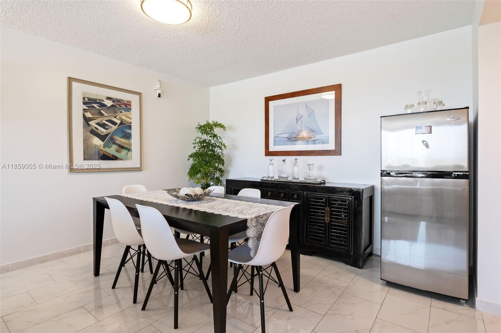 17890 West Dixie Highway, Unit 603 Miami, FL 33160 - Photo 10 of 34 a dining room with a table and chairs