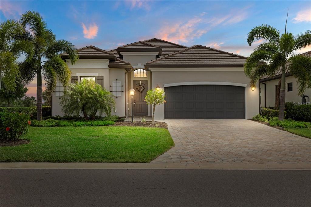 5811 Brandon Run Bradenton, FL 34211 - Photo 1 of 1 a front view of a house with a garden and garage