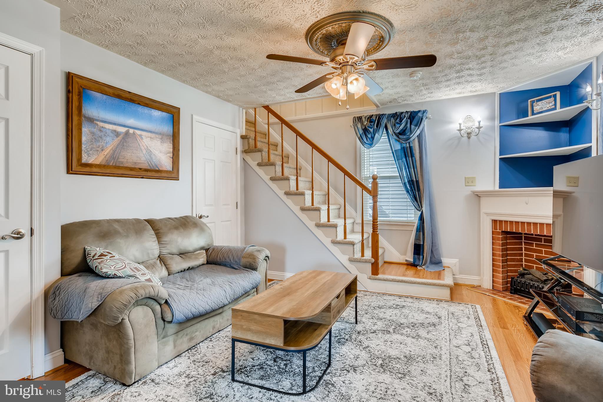 820 Martin Road Baltimore, MD 21221 - Photo 19 of 50 Living Room w/ Ceiling Fan, wood floors, built ins
