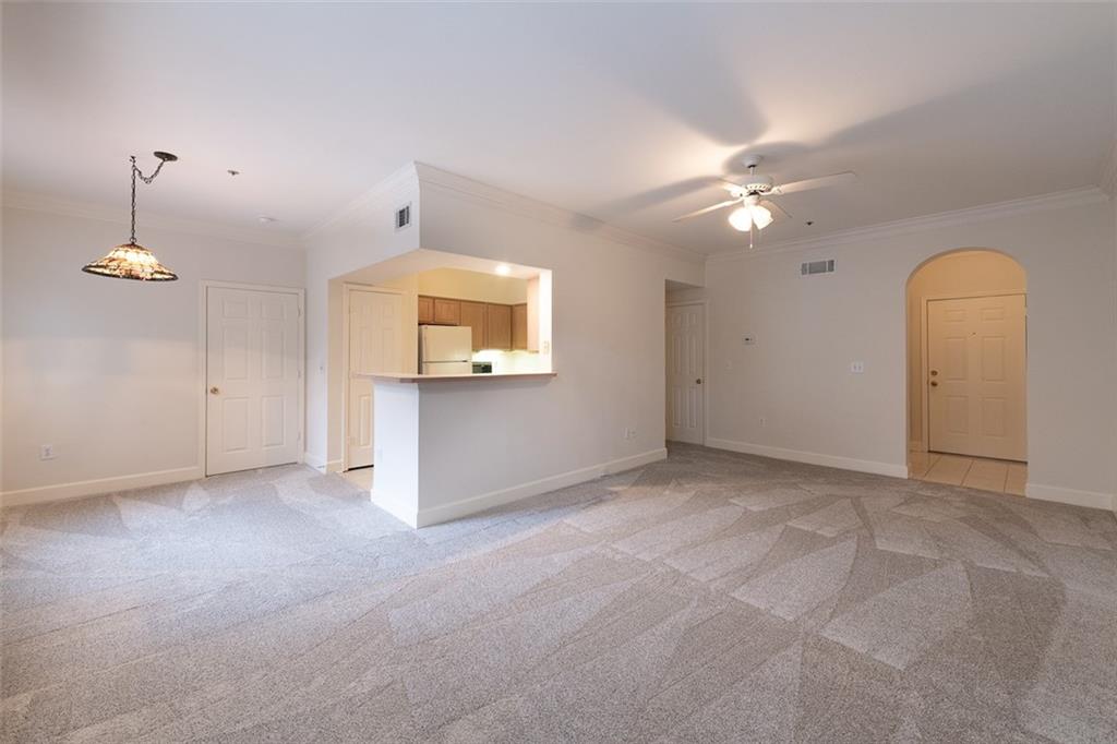 an empty room with a ceiling fan and a window