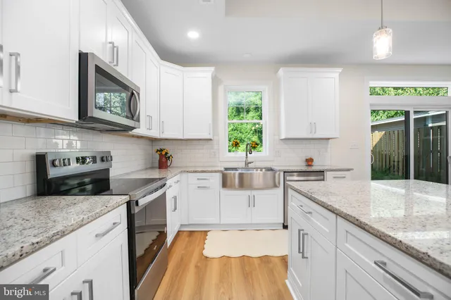 a kitchen with a stove a sink and a microwave