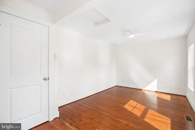 an empty room with wooden floor