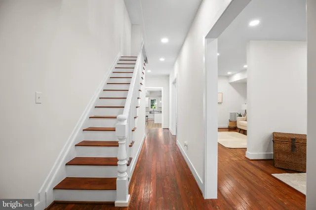 a view of entryway and hall with wooden floor