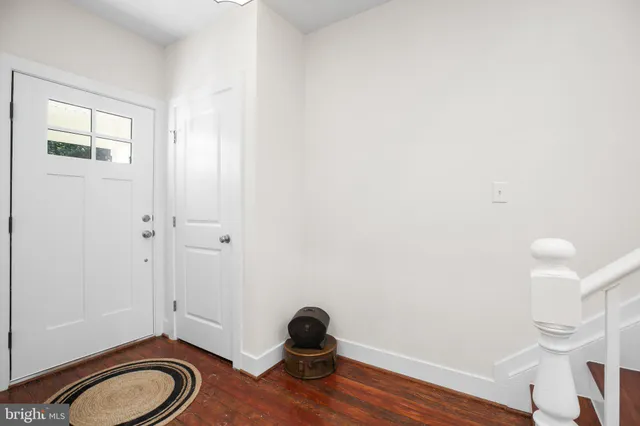 a view of a livingroom with wooden floor and a window