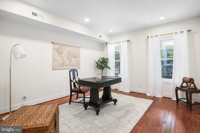 a view of a workspace with furniture and a window