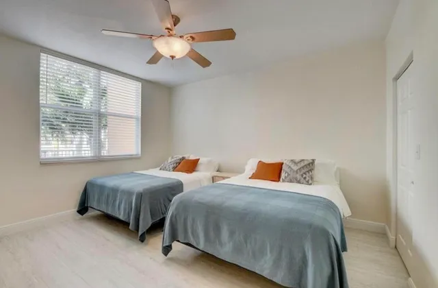 a bedroom with two beds and a chandelier