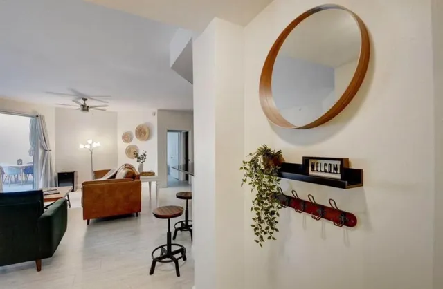a living room with furniture and a mirror