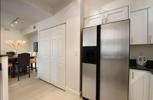 a kitchen with stainless steel appliances refrigerator and cabinets