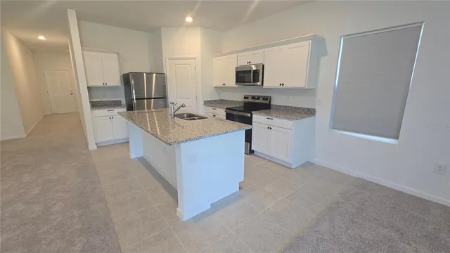 a kitchen with a sink a stove and refrigerator