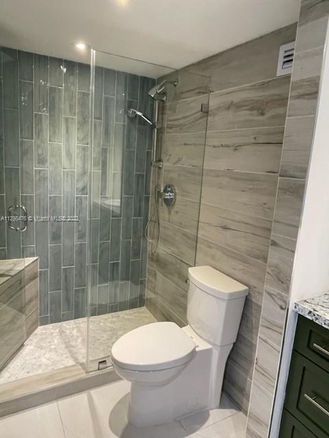 9225 Collins Avenue, Unit 1407 Surfside, FL 33154 - Photo 6 of 7 a bathroom with a toilet and shower
