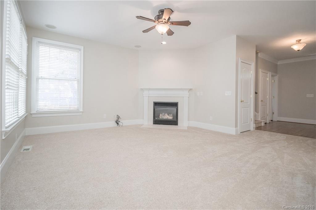 1376 Barnett Woods Fort Mill, SC 29708 - Photo 16 of 34 an empty room with chandelier fan and windows