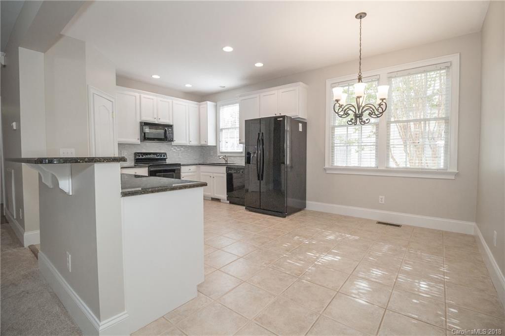 1376 Barnett Woods Fort Mill, SC 29708 - Photo 20 of 34 a kitchen with kitchen island a refrigerator sink and microwave