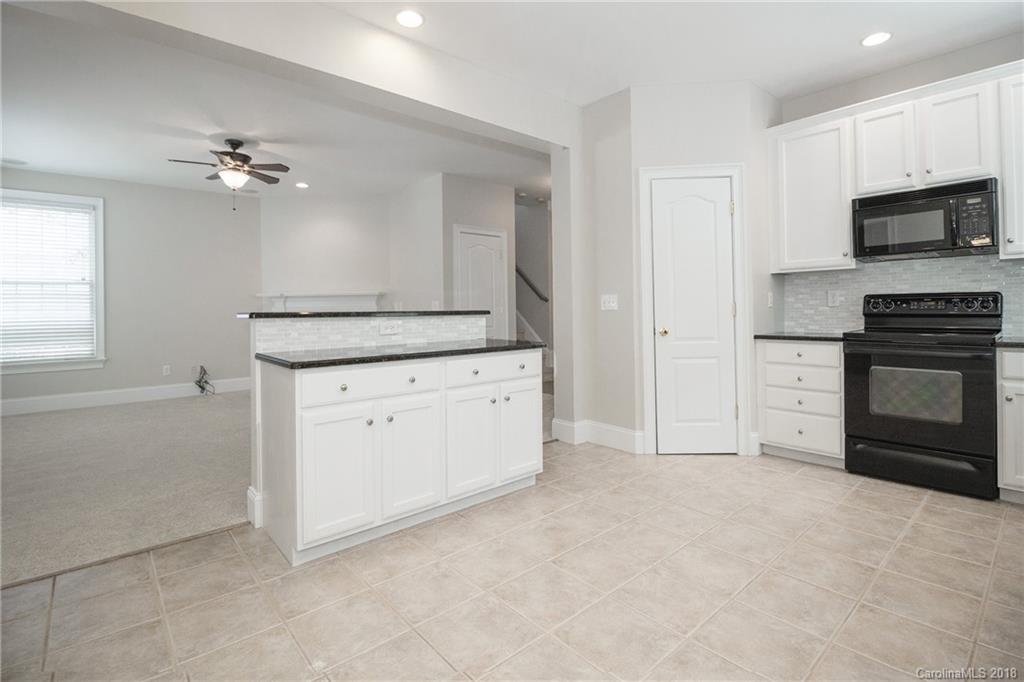 1376 Barnett Woods Fort Mill, SC 29708 - Photo 21 of 34 a kitchen with stainless steel appliances granite countertop a stove a sink and a refrigerator