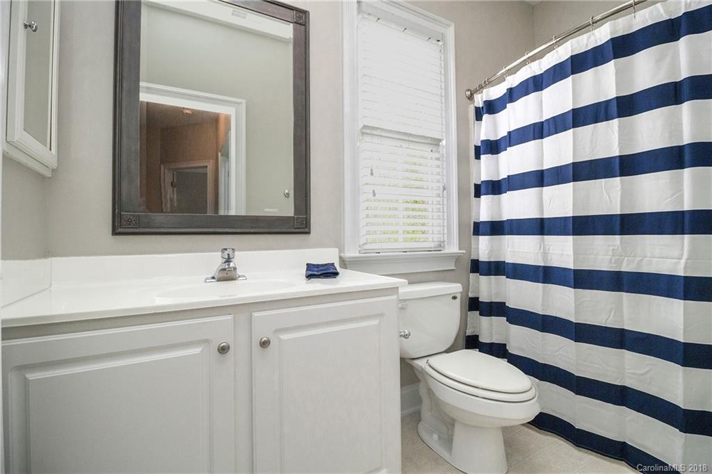 1376 Barnett Woods Fort Mill, SC 29708 - Photo 28 of 34 a bathroom with a sink a toilet a mirror and shower