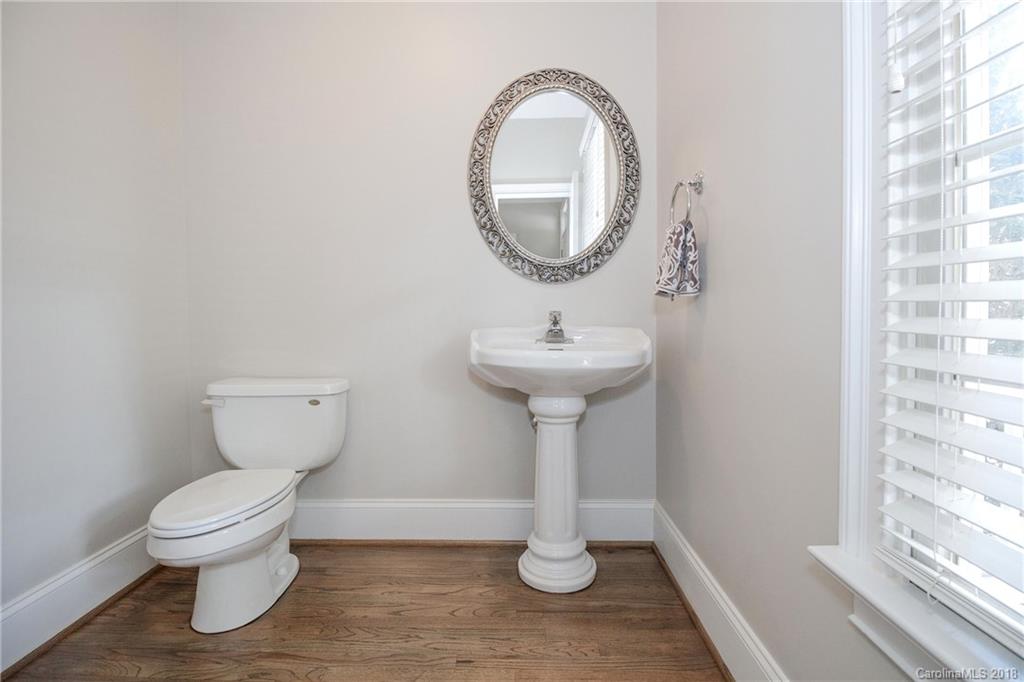 1376 Barnett Woods Fort Mill, SC 29708 - Photo 7 of 34 a bathroom with a toilet sink and mirror