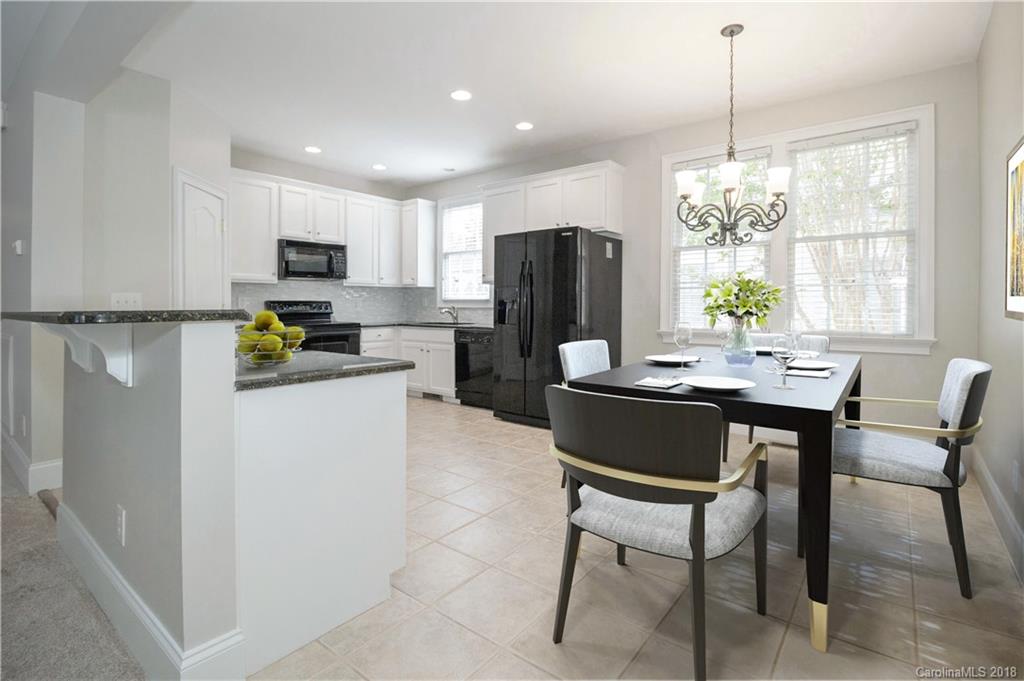 1376 Barnett Woods Fort Mill, SC 29708 - Photo 9 of 34 a kitchen with a refrigerator a dining table and chairs