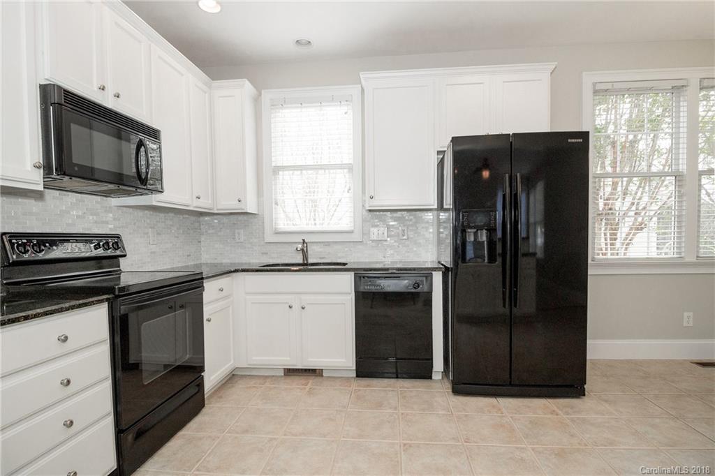 1376 Barnett Woods Fort Mill, SC 29708 - Photo 10 of 34 a kitchen with a refrigerator and a stove top oven
